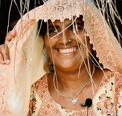Beneficiary receiving sewing equipment in Sindh