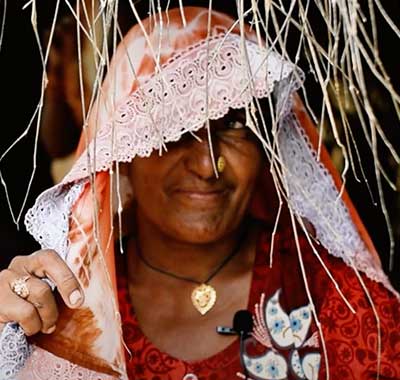 Female micro-entrepreneur running village store